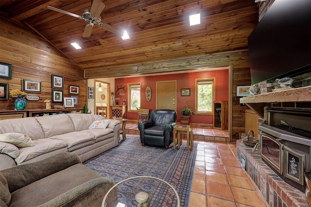 living area featuring wooden walls, high vaulted ceiling, wooden ceiling, a ceiling fan, and light tile patterned floors