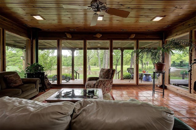 sunroom featuring tile patterned flooring and wood walls