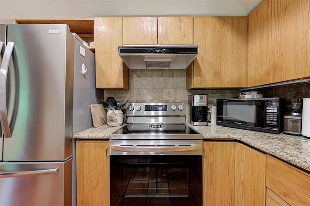kitchen with backsplash, stainless steel appliances, light stone countertops, and under cabinet range hood