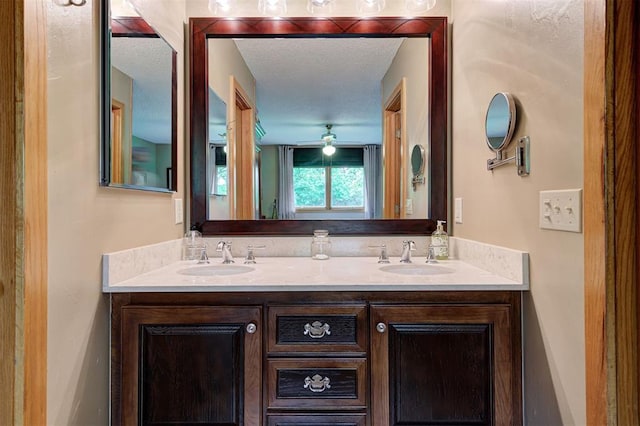 full bathroom featuring double vanity, a sink, and a ceiling fan