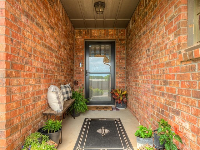 doorway to property with brick siding