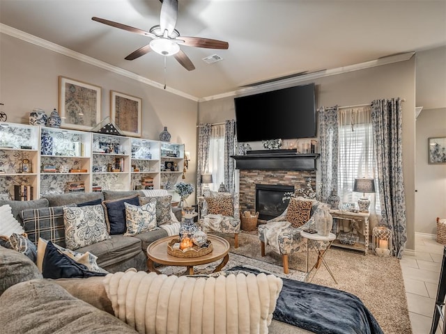 living room with visible vents, ornamental molding, tile patterned flooring, a stone fireplace, and ceiling fan