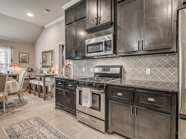 kitchen with crown molding, light tile patterned flooring, appliances with stainless steel finishes, decorative backsplash, and vaulted ceiling