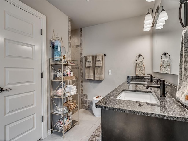 bathroom with double vanity, tile patterned floors, an inviting chandelier, and a sink