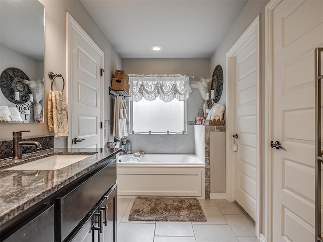full bath featuring vanity, tile patterned floors, a garden tub, and recessed lighting