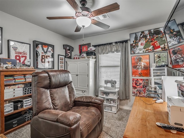 sitting room featuring carpet floors, baseboards, a ceiling fan, and visible vents