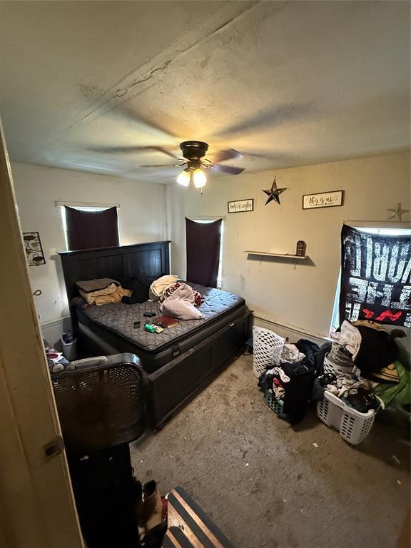 902 S Hitchite St, Wewoka, OK 74884 - carpeted bedroom featuring a ceiling fan