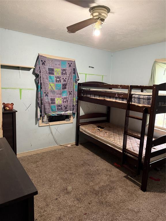 902 S Hitchite St, Wewoka, OK 74884 - bedroom with carpet flooring, a textured ceiling, and baseboards