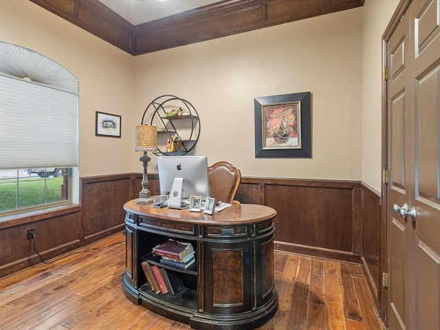 office with wainscoting, hardwood / wood-style floors, wood walls, and ornamental molding