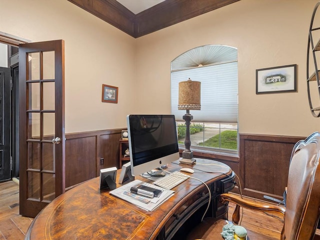 office with a wainscoted wall, wood finished floors, and ornamental molding
