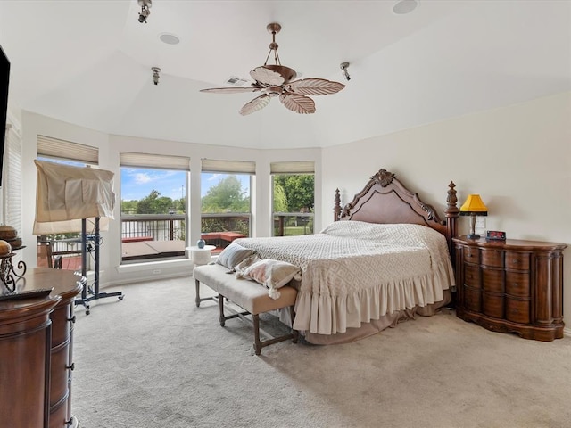 bedroom featuring carpet, access to outside, multiple windows, lofted ceiling, and ceiling fan