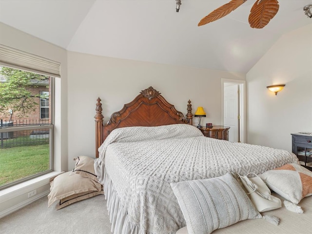 carpeted bedroom with lofted ceiling