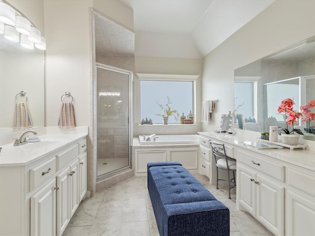 bathroom featuring a stall shower, two vanities, a bath, and vaulted ceiling