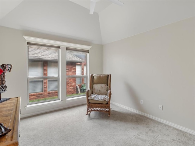living area featuring carpet, baseboards, and high vaulted ceiling
