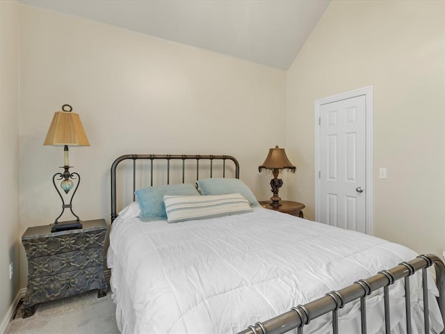 carpeted bedroom featuring vaulted ceiling