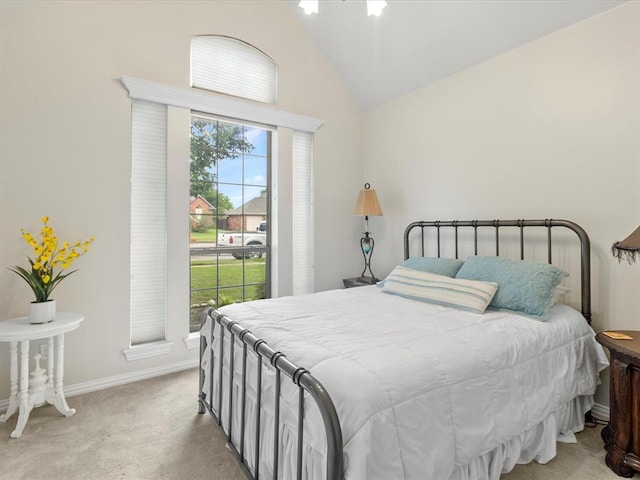 bedroom with carpet floors, baseboards, and high vaulted ceiling
