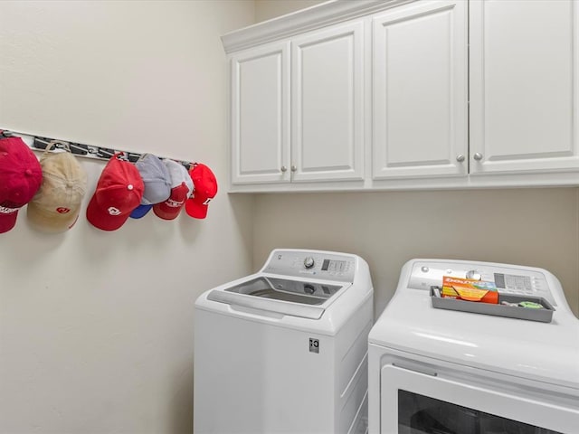 laundry area featuring independent washer and dryer and cabinet space