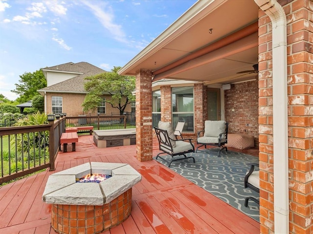 deck featuring a fire pit and a jacuzzi
