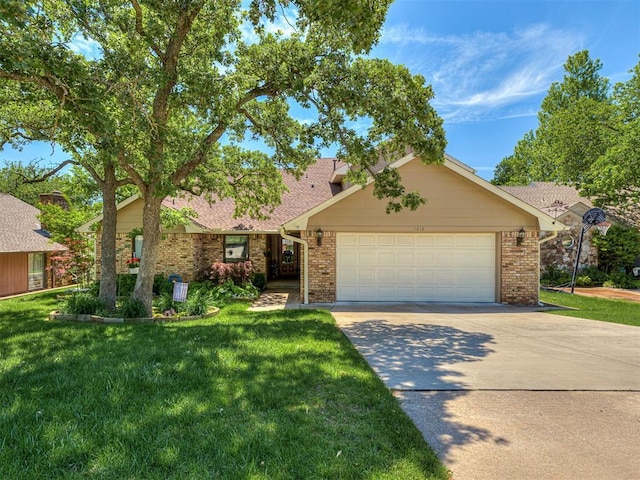 view of front of house with brick siding, a garage, a front lawn, and concrete driveway
