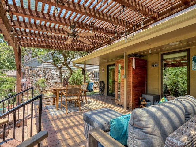 wooden terrace featuring a pergola, a ceiling fan, and outdoor dining area