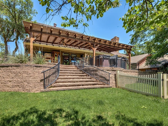 exterior space with fence, stairs, a chimney, and a yard
