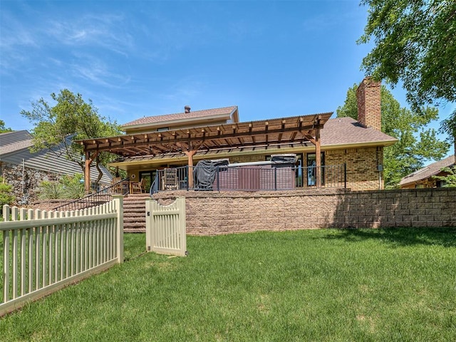 rear view of property featuring a chimney, a lawn, brick siding, fence, and a pergola