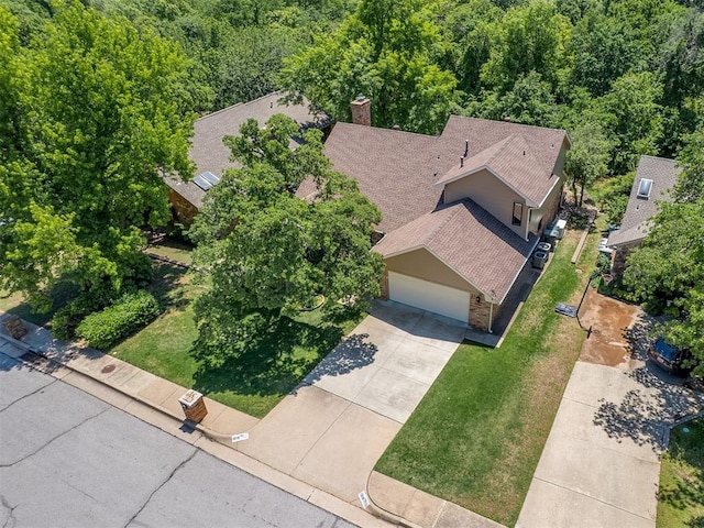drone / aerial view featuring a wooded view