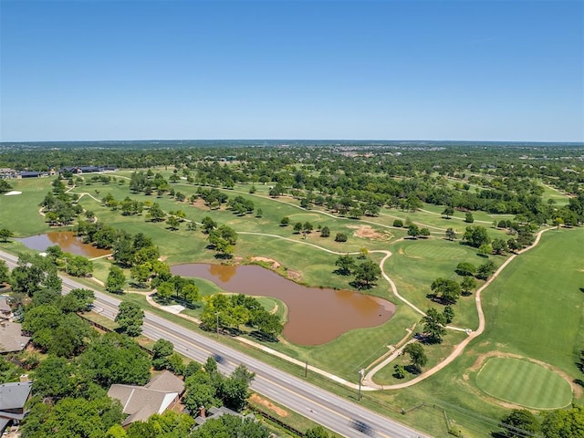 drone / aerial view with a water view and view of golf course