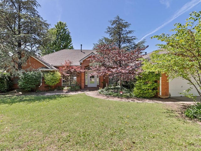 view of front of house featuring brick siding, a garage, roof with shingles, and a front yard