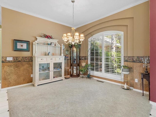 unfurnished dining area with crown molding, carpet, a notable chandelier, and visible vents