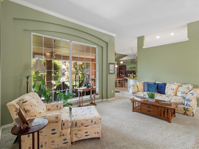 living room featuring baseboards, ornamental molding, and carpet