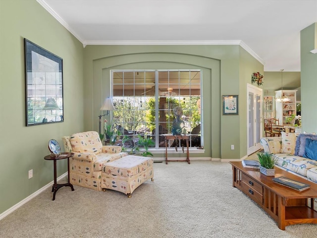 sitting room with baseboards, ornamental molding, and carpet flooring