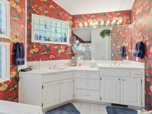 full bathroom with a sink, tile patterned floors, plenty of natural light, and wallpapered walls