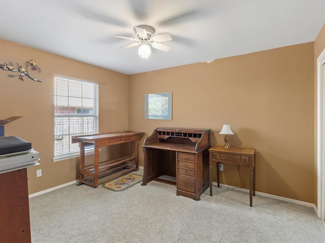 carpeted office with baseboards and ceiling fan