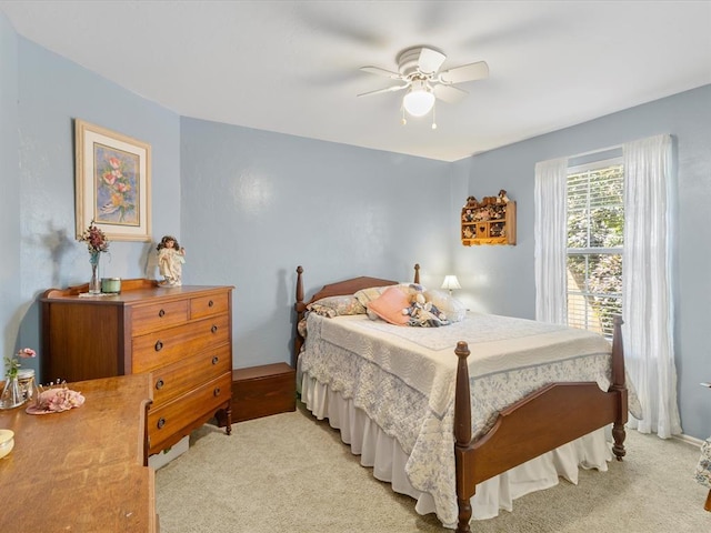 bedroom with light carpet and a ceiling fan