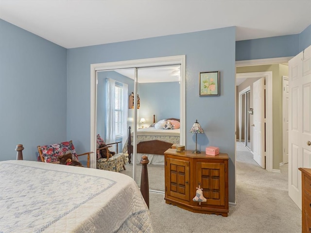 carpeted bedroom with baseboards and a closet