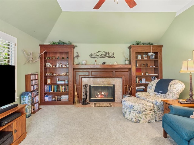 living room with ceiling fan, a fireplace, vaulted ceiling, and carpet flooring