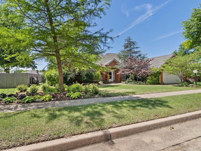 1816 Robin Ridge Dr, Norman, OK 73072 - view of property hidden behind natural elements featuring roof with shingles