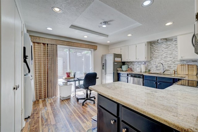 6000 N Pennsylvania Ave Unit 59, Oklahoma City, OK 73112 - kitchen with a sink, a textured ceiling, a tray ceiling, and stainless steel appliances