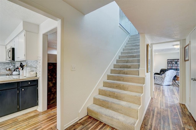 6000 N Pennsylvania Ave Unit 59, Oklahoma City, OK 73112 - stairs with baseboards and wood finished floors