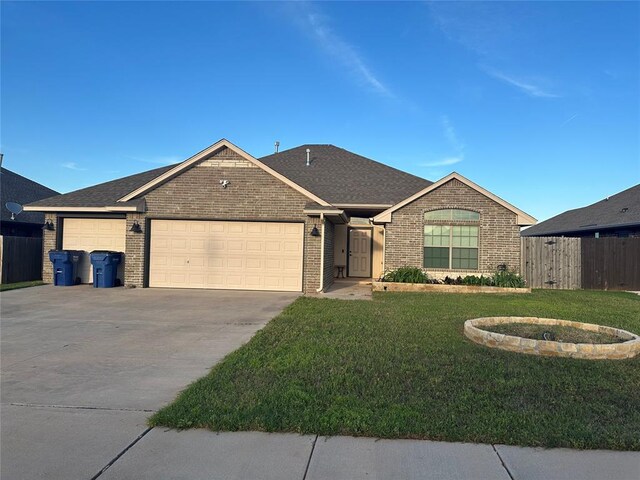 single story home with brick siding, fence, a garage, concrete driveway, and a front yard