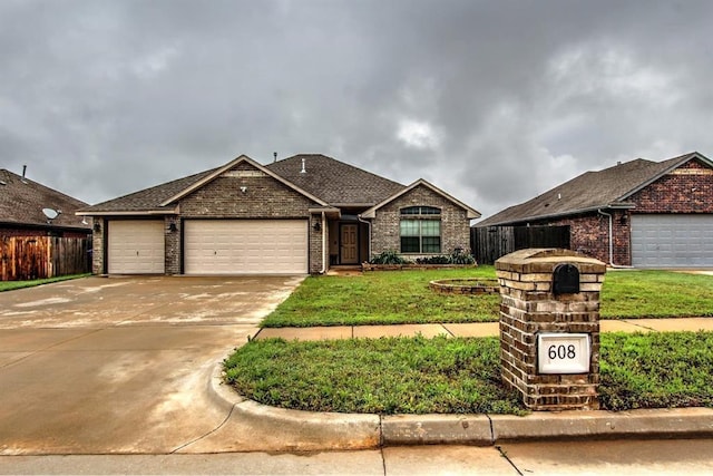 ranch-style house with brick siding, an attached garage, and concrete driveway
