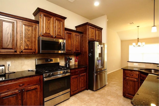 kitchen featuring stainless steel appliances, tasteful backsplash, a sink, lofted ceiling, and a chandelier