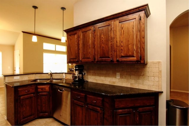 kitchen with stainless steel dishwasher, a sink, tasteful backsplash, arched walkways, and a peninsula