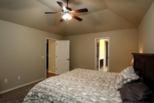 bedroom featuring vaulted ceiling, dark colored carpet, baseboards, and a ceiling fan