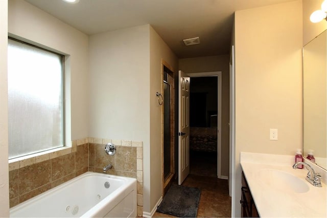 bathroom featuring a jetted tub, vanity, and a shower stall