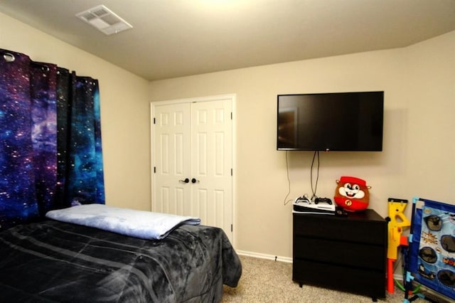carpeted bedroom with baseboards and a closet