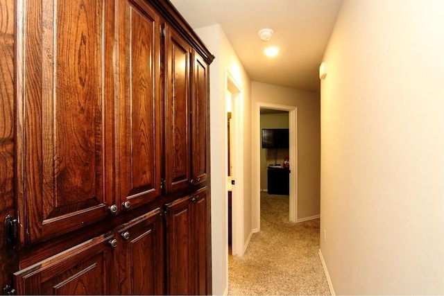 hall with light carpet and baseboards
