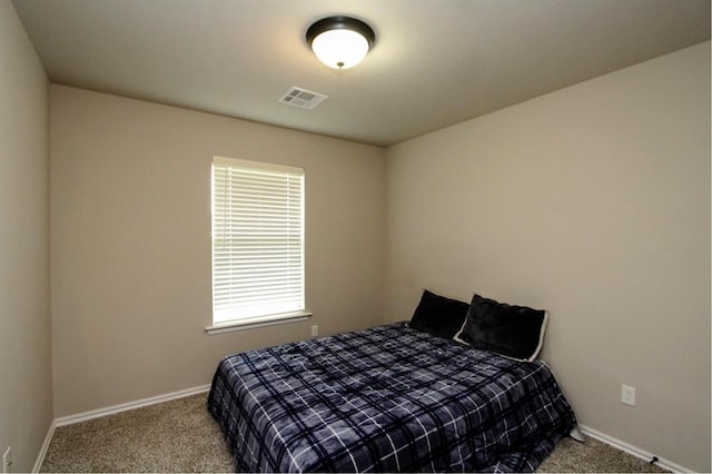 bedroom with carpet flooring and baseboards