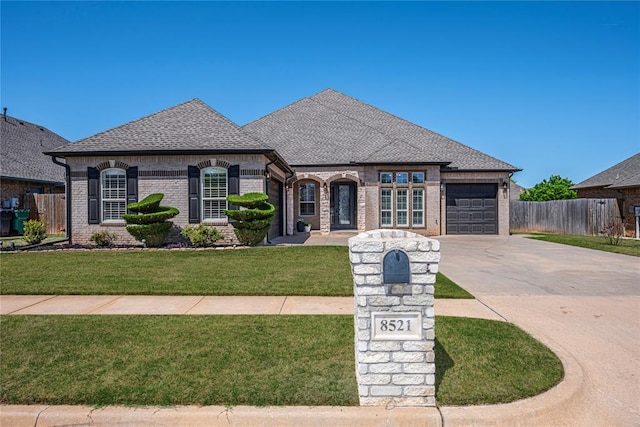 8521 NW 124th St, Oklahoma City, OK 73142 - french provincial home with driveway, an attached garage, brick siding, and a shingled roof